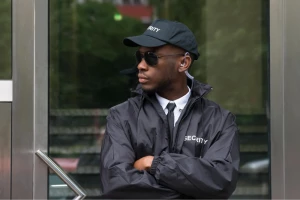 security guard standing arms crossed